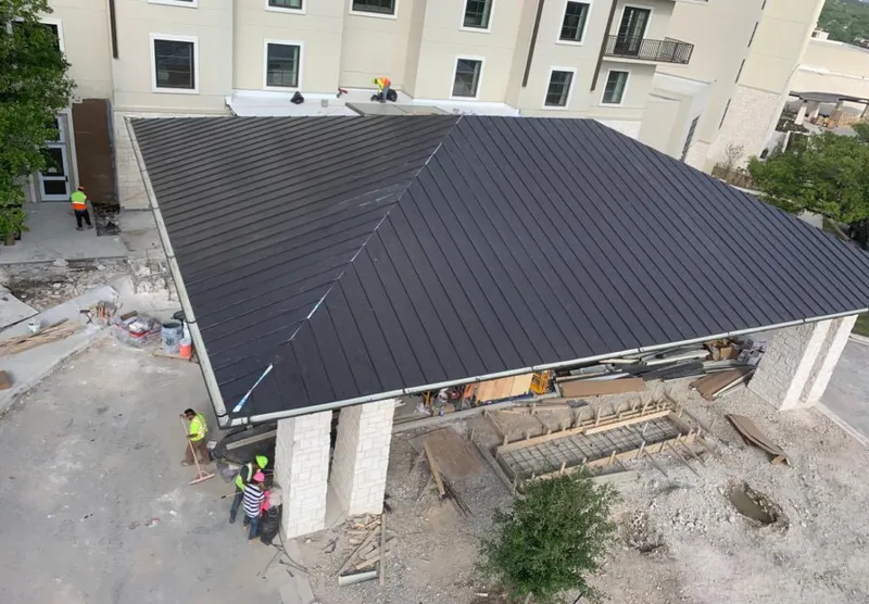 Metal roofing installation team working on a commercial building in Haltom City
