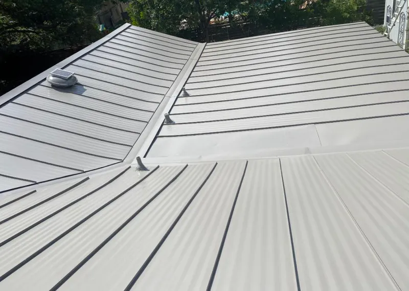 Solar attic fan installed on a metal roof for Roof Ventilation in Haltom City